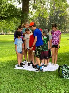A small group of participants ages 10-13 participate in an outdoor portion of the second annual New Castle History Summer Camp.