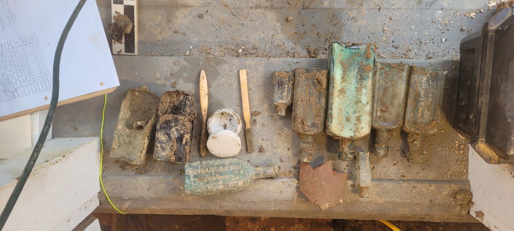 Some of the interesting items found in the Buena Vista privy include hair dye bottles, toothbrushes and a toothpaste container (shown in this image).