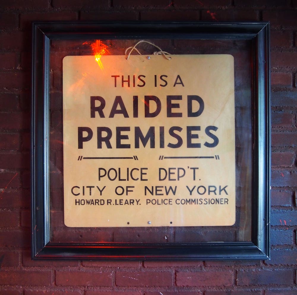 A sign that reads, “This is a raided premises. Police Dept. City of New York…”