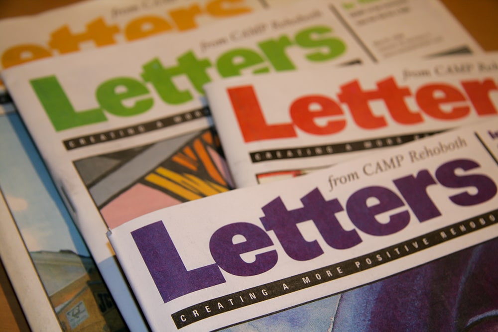 A detail photograph of Four issues of Letters from CAMP Rehoboth.