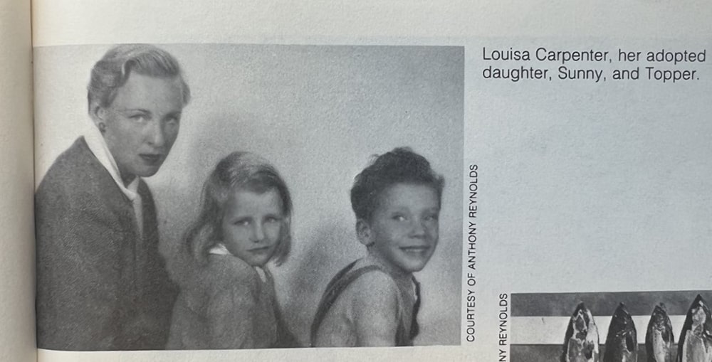 A white woman with 2 white children, a girl and a boy, sit in a line and pose for the camera.