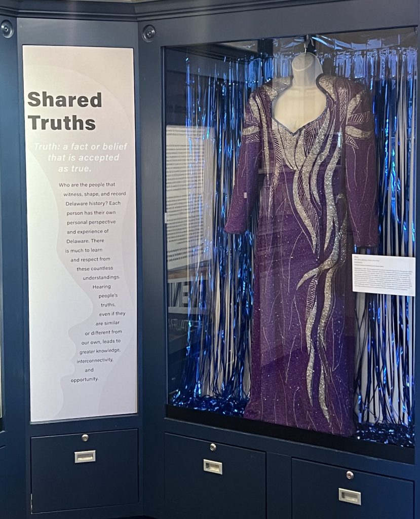 Silver and purple evening gown in a glass case