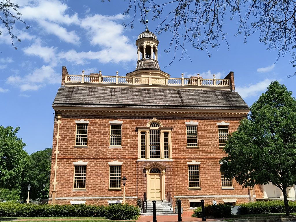 A colonial-style court house with red brick and a large bell tower