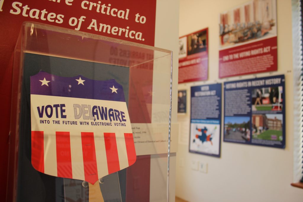 A red white and blue promotional fan advertising electronic voting in the state of Delaware