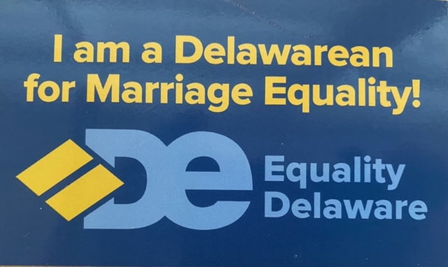 A blue bumper sticker with yellow text reading “I am a Delawarean for Marriage Equality!”
