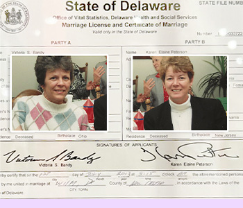 Composition of Vikki Bandy and Karen Peterson overlaid on the first Same-Sex marriage license. Their signatures are seen below their names.