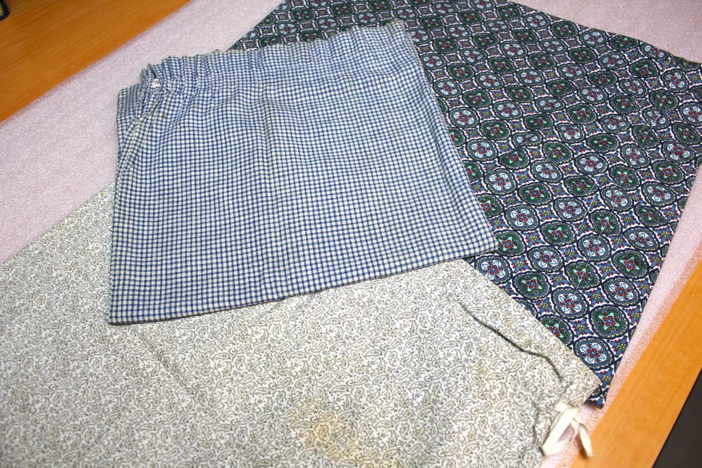 Flour sacks of various colors and patterns, including paisley and gingham 