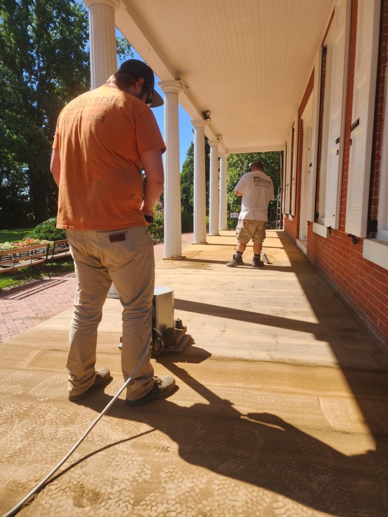 Workers repair the porch at Buena Vista