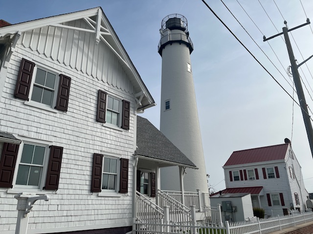 Image of the Fenwick Island Lighthouse beside the innkeeper's house at its base