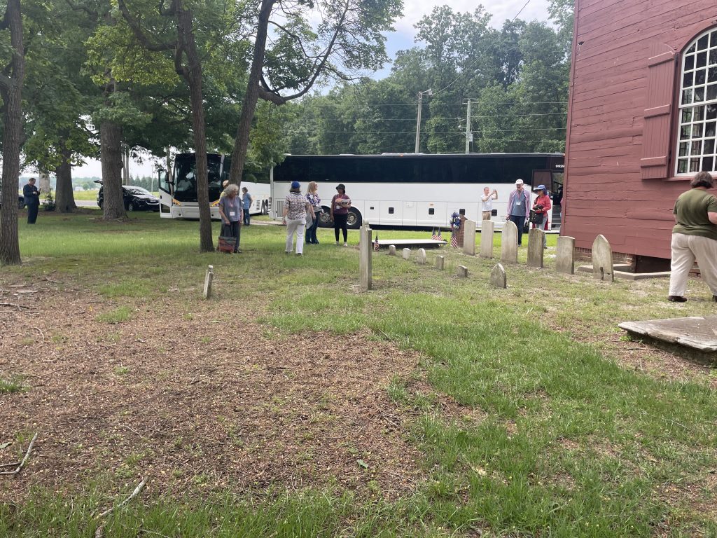 VAF members examining the cemetery behind Old Christ Church near Laurel during a conference in 2025.