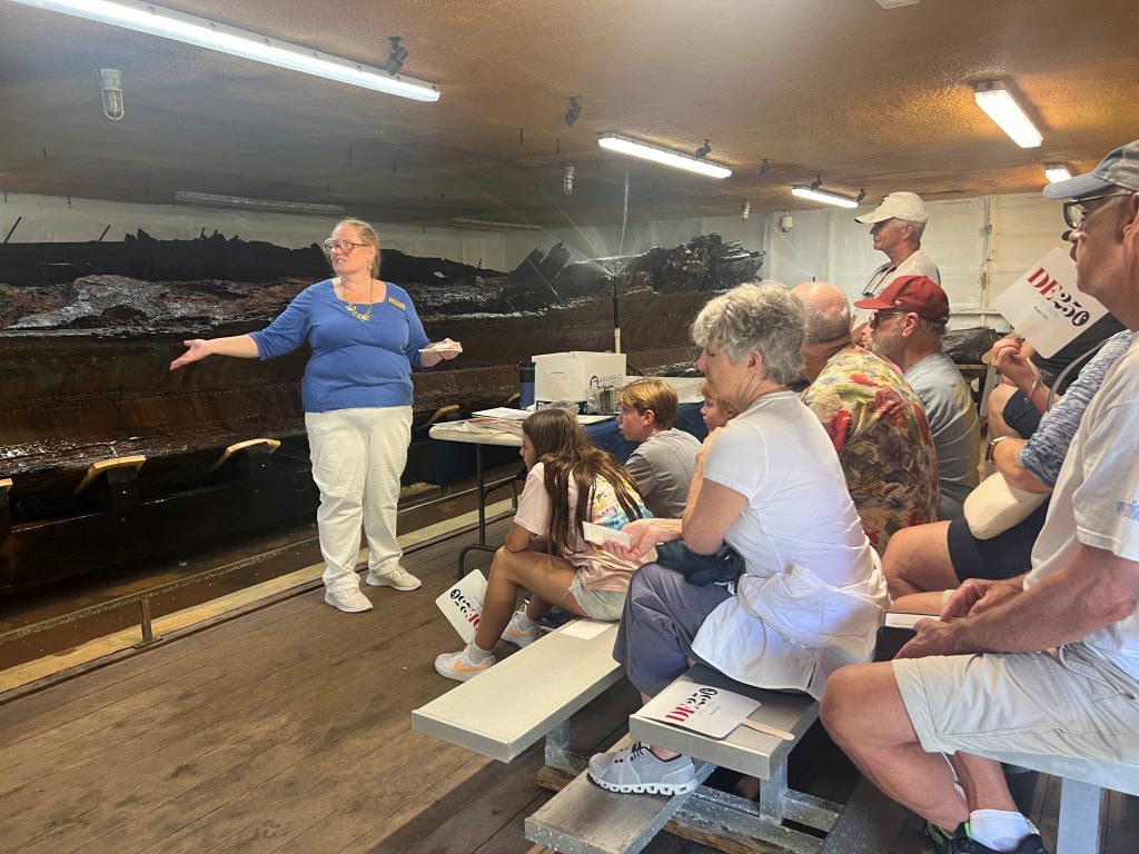 Visitors learn about the artifacts collected from the HMS DeBraak shipwreck.