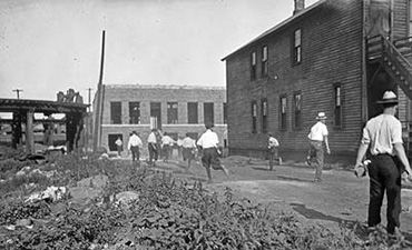 Mob running with bricks during the race riots in Chicago, Illinois, 1919
