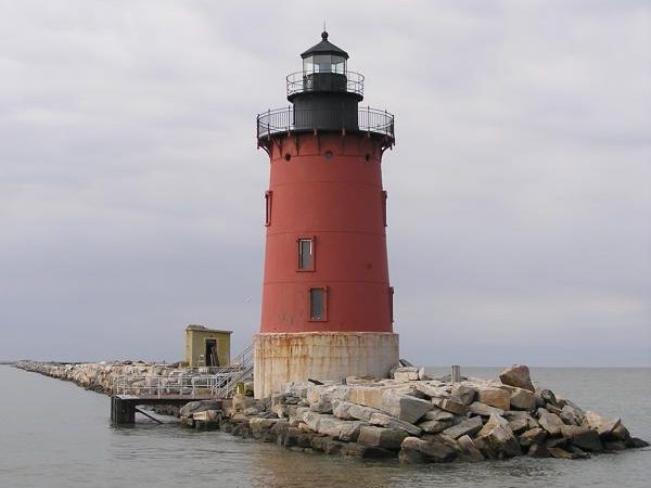 DE Breakwater East End Lighthouse, a soft red cylindrical light house with a black metal landing at the top.